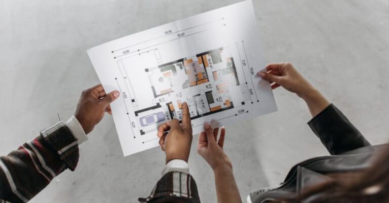 Measures - Couple Holding Blueprint of a House