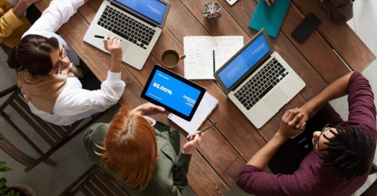 Employees - Top View Photo of Group of People Using Macbook While Discussing